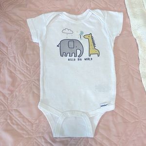 White onsie w/ wording “Hello big world” on front.